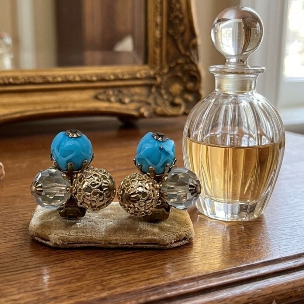 Vintage Vogue ornate clip on earrings. Ab and blue glass .